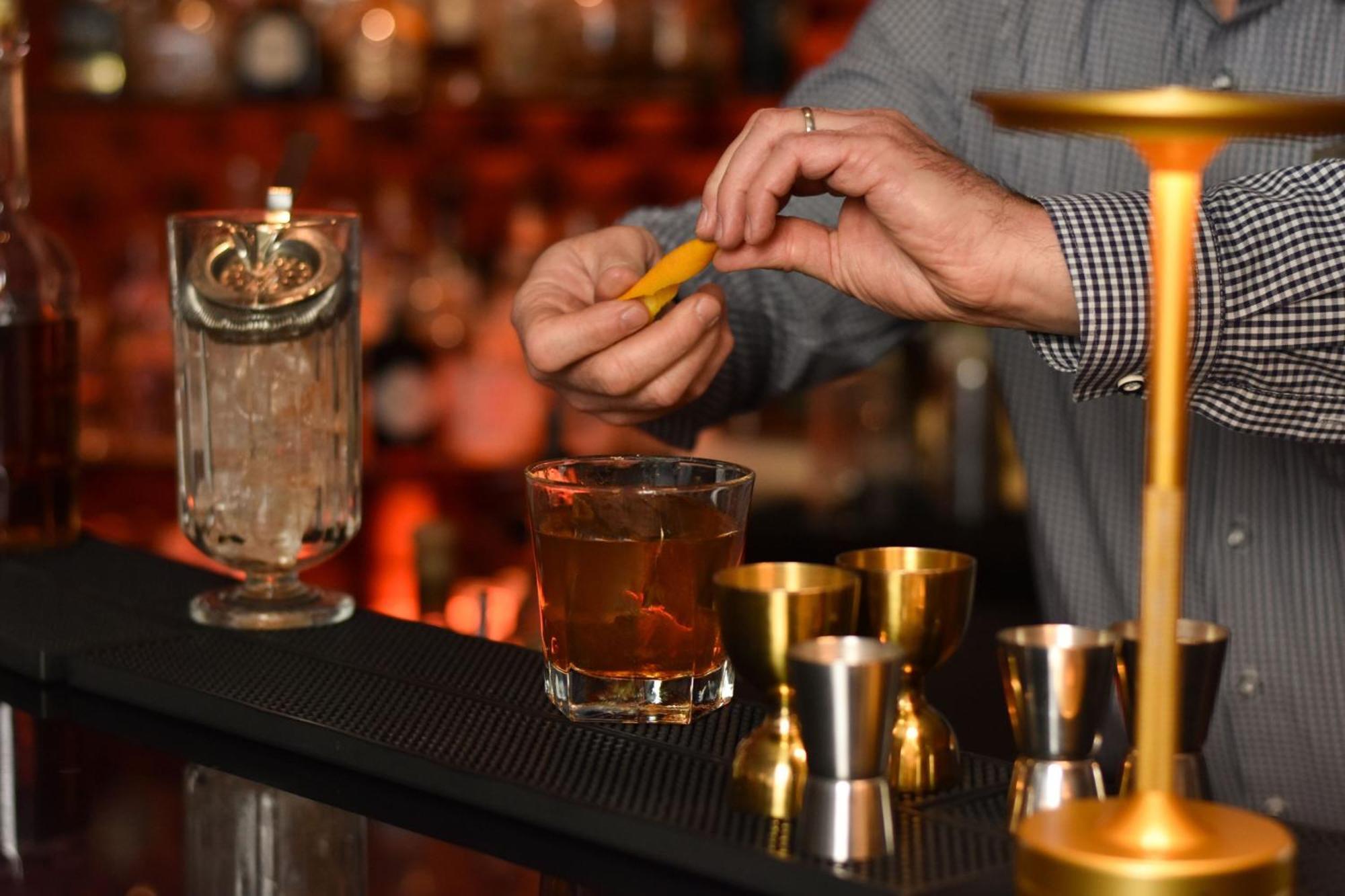 Cologne Marriott Hotel Kültér fotó A bartender adding a lemon twist to a cocktail
